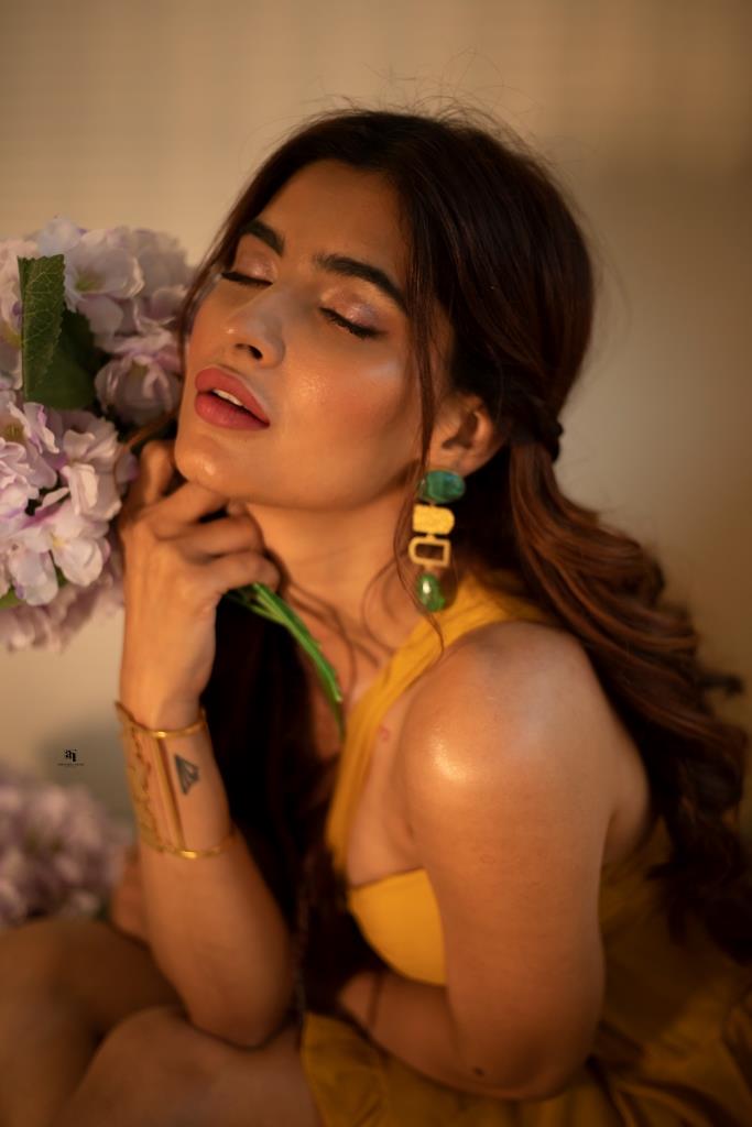 Girl in great mood poses with gift in her hands. Portrait of blonde woman  in massive earrings and s Stock Photo by look_studio